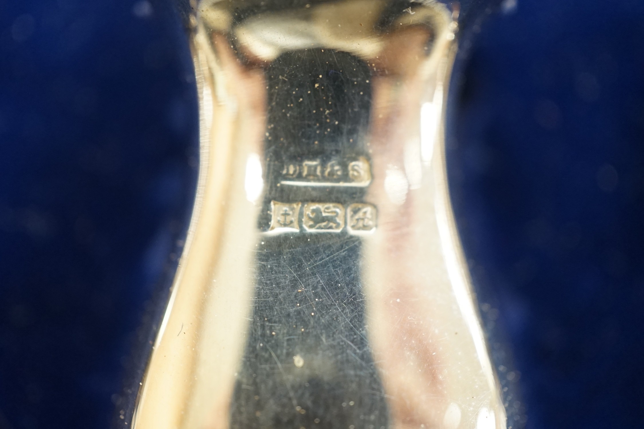 A modern silver three piece condiment set, and two spoons, boxed, Birmingham, 1975.